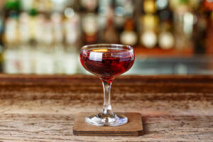 A whiskey-based cocktail with vermouth, Manhattan. Cocktail aperitif on the bar in the nightclub, space for text